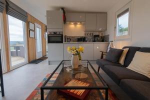 a living room with a couch and a table at The Paddock- Loch Lomond and Trossachs in Gartmore