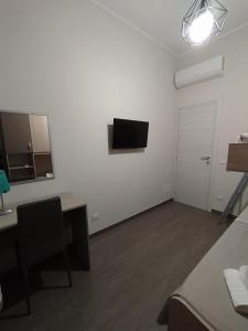 Televízia a/alebo spoločenská miestnosť v ubytovaní Casa Violetta