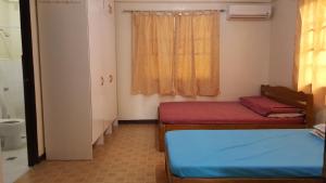 Postel nebo postele na pokoji v ubytování Sanctuary Transient House Bacolod