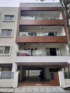 an apartment building with a balcony and a porch at Castle BGR in Bangalore