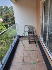 a metal bench sitting on a balcony with a view at Castle Bannerghatta Road in Bengaluru +11 photos
