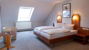 Postel nebo postele na pokoji v ubytování Hotel Am Uenglinger Tor