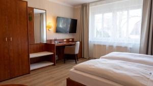 Postel nebo postele na pokoji v ubytování Hotel Am Uenglinger Tor