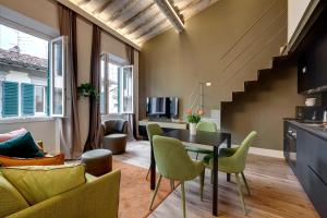 a kitchen and living room with a table and chairs at Turandot Apartment by Mamo Florence in Florence