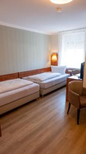 Postel nebo postele na pokoji v ubytování Hotel Am Uenglinger Tor