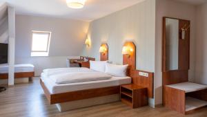 Postel nebo postele na pokoji v ubytování Hotel Am Uenglinger Tor