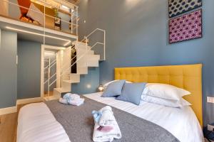 a bedroom with a bed and a staircase at Turandot Apartment by Mamo Florence in Florence