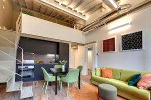 a living room with a couch and a table and chairs at Turandot Apartment by Mamo Florence in Florence