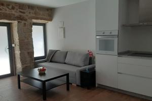a living room with a couch and a coffee table at Casas da Bríxida. Apartamento accesibel in Cangas de Morrazo