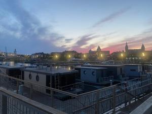 a view of a city at night with buildings at Hausboot - Domy na wodzie - Houseboat Porta Mare - Odradream in Szczecin