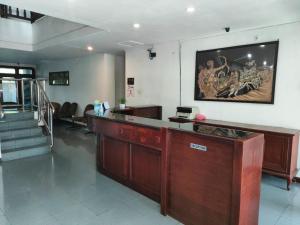 a lobby with a bar with a picture on the wall at Wisma Hari Kota in Medan
