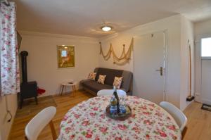 a living room with a table and a couch at Bavica Apartments in Rovinj