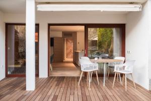 a dining room with a table and chairs on a deck at Our Second Home in Kranjska Gora in Kranjska Gora