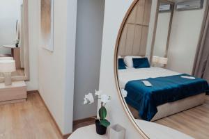 a bedroom with a bed and a mirror at Cesare ai Cavalieri Suites in Rome