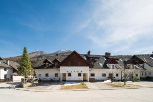 a large white building with black roof at Our Second Home in Kranjska Gora in Kranjska Gora
