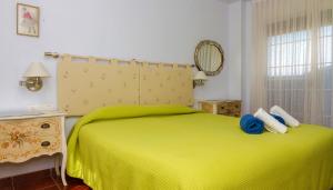 a bedroom with a green bed and a window at Casa Torre del Virrey in La Eliana +20 photos