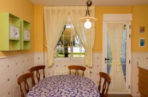 a dining room with a table and a window at Casa Torre del Virrey in La Eliana