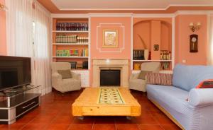 a living room with a couch and a fire place at Casa Torre del Virrey in La Eliana