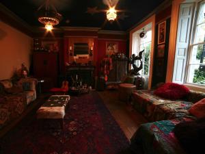 a living room with a couch and a table at The Covenstead in Glastonbury