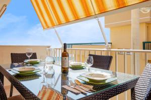 a table with a bottle of wine on a balcony at Pegaso House in Pozzallo