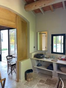 a kitchen with a counter and a table with a mirror at LES BARTAVELLES in Aix-en-Provence
