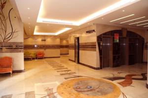 a lobby with a large rug on the floor at Al Bostan Al Masi Hotel in Mecca