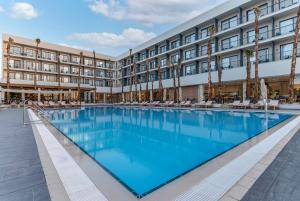 a large pool in front of a hotel at Gomeh by Isrotel Design in Tiberias