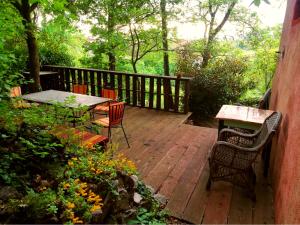 a wooden deck with a table and chairs on it at Krasberry in Komen