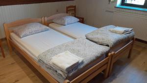 two twin beds with towels on top of them at Country House Aleš in Gornja Bistrica