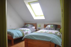 En eller flere senge i et værelse på Le Pressoir