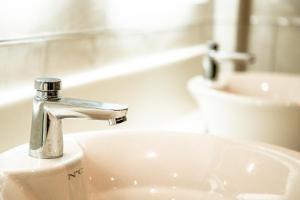 a bathroom with a sink and a faucet at Oastbrook Glamping in Bodiam