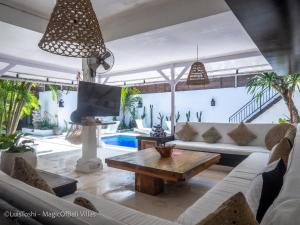 a living room with a couch and a table at Ocean Luxury Villas - Seminyak in Seminyak