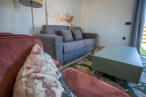 a living room with a couch and a table at ON City Apartments in Matalascañas