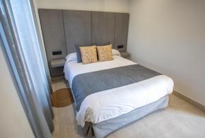 a bedroom with a large bed in a room at ON City Apartments in Matalascañas