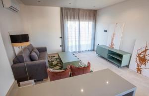a living room with a couch and a table at ON City Apartments in Matalascañas