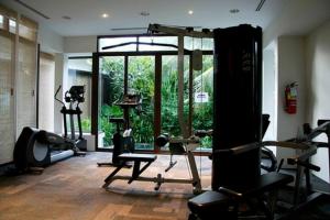 a gym with several tread machines and a large window at Kata Gardens Penthouse sea view 4C in Kata Beach