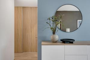 a bathroom with a mirror and a vase on a counter at Metropolitan Star Apart Hotel in Bratislava