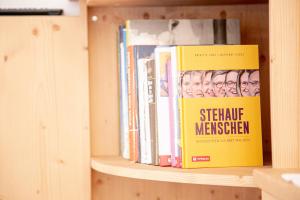 a book shelf with several books on it at Haus Reindl in Leutasch