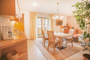 a kitchen and dining room with a table and chairs at Haus Reindl in Leutasch