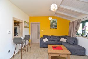 a living room with a blue couch and a table at House Marta 2157 in Žminj