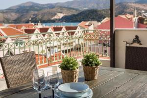 a table with wine glasses and a view of a city at Panoramic Luxurious Penthouse in Argostoli +12 photos