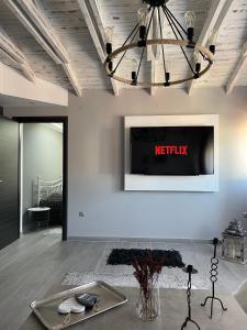 a living room with a television on a wall at Florina Sky Loft in Florina