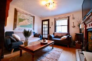 a living room with a couch and a coffee table at Cockle Cottage, An artists haven, Charming Cottage By Air Premier in Seaford