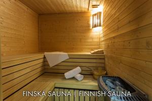 a sauna with a bench in a wooden tub at Hotel Karlštejn & SPA in Karlštejn