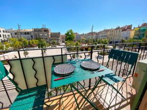 a blue table and chairs on a balcony at Hotel Relais Du Postillon in Antibes