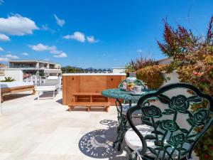 a table and a chair on a patio at Home Avenue Luxury Townhouse in Olbia