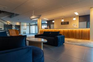 a lobby with couches and a table and a bar at Meri Seaside Hotel & SPA in Kuressaare