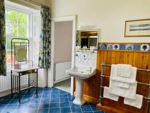 a bathroom with a sink and a mirror at West Plean House in Stirling