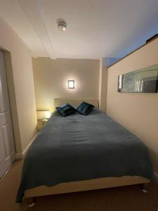 a bedroom with a large bed with two pillows on it at Flat 1 Chestergate in Macclesfield