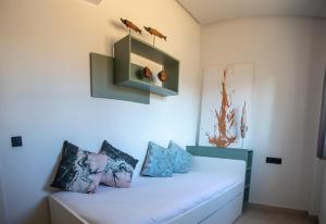 a room with a bed with two birds on the wall at ON City Apartments in Matalascañas